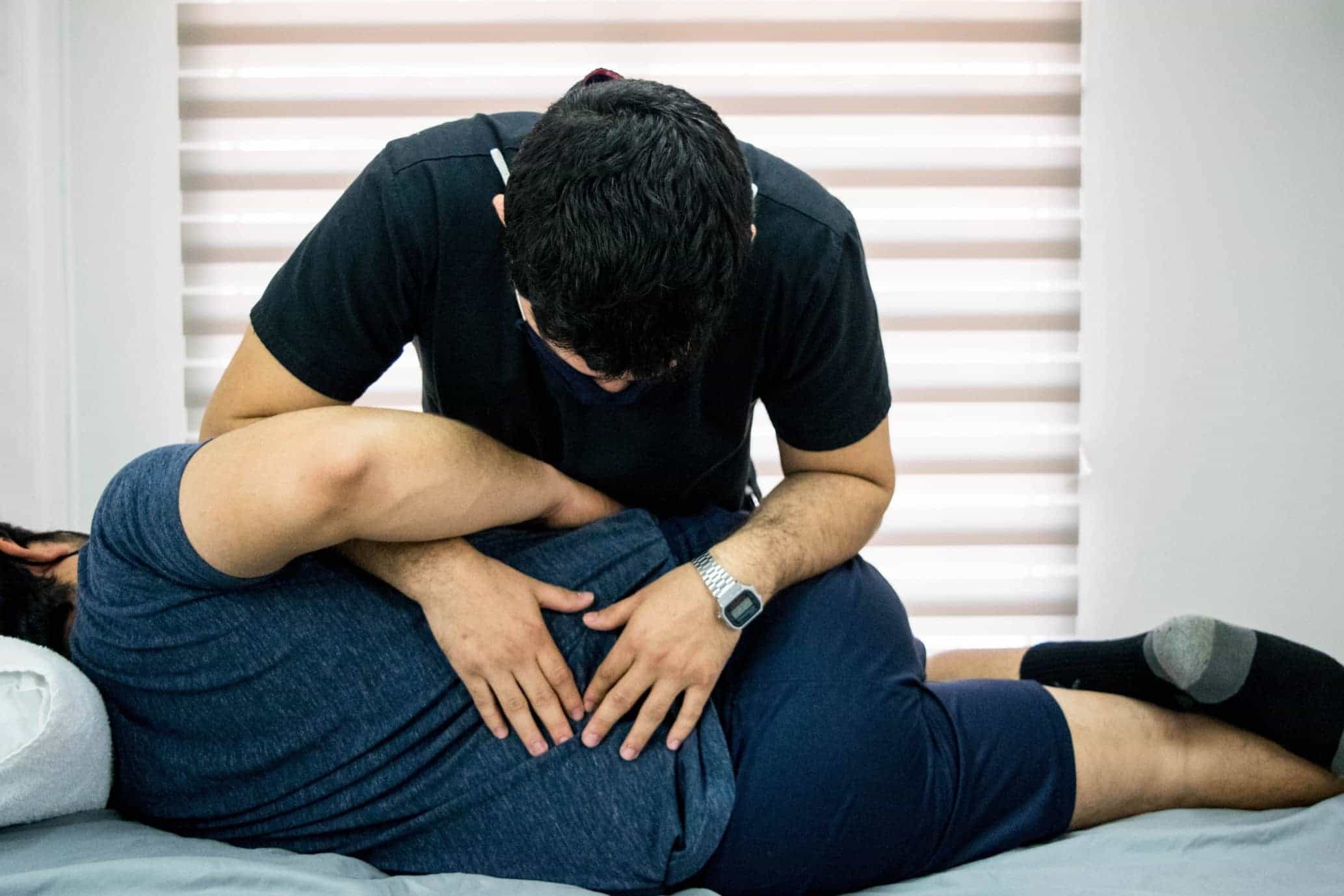 Physiotherapist working on patients back