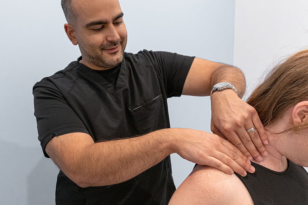 Physiotherapist working on patients neck problem