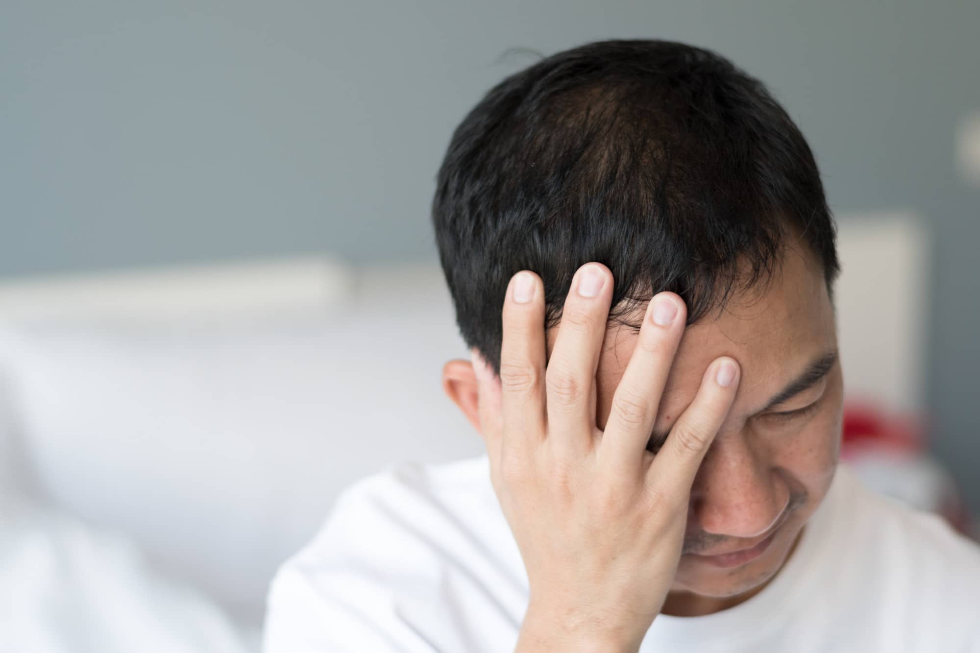 Men holding his head after getting a concussion