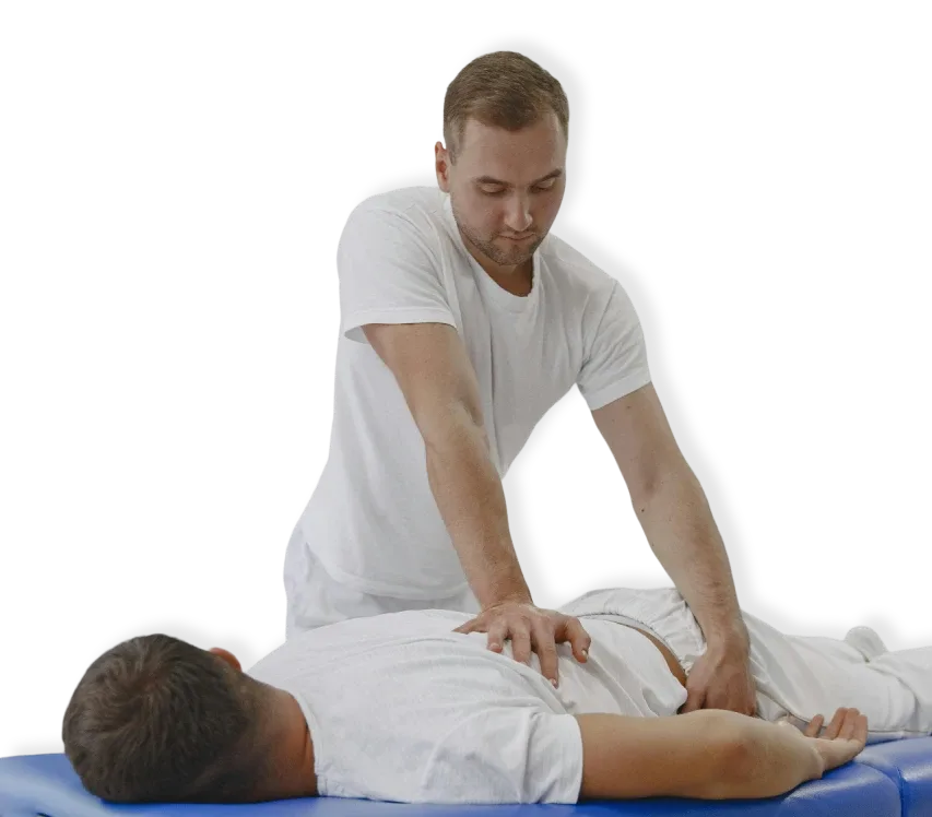 A chiropractor performing a back massage on a client lying face down on a massage table in North Vancouver.