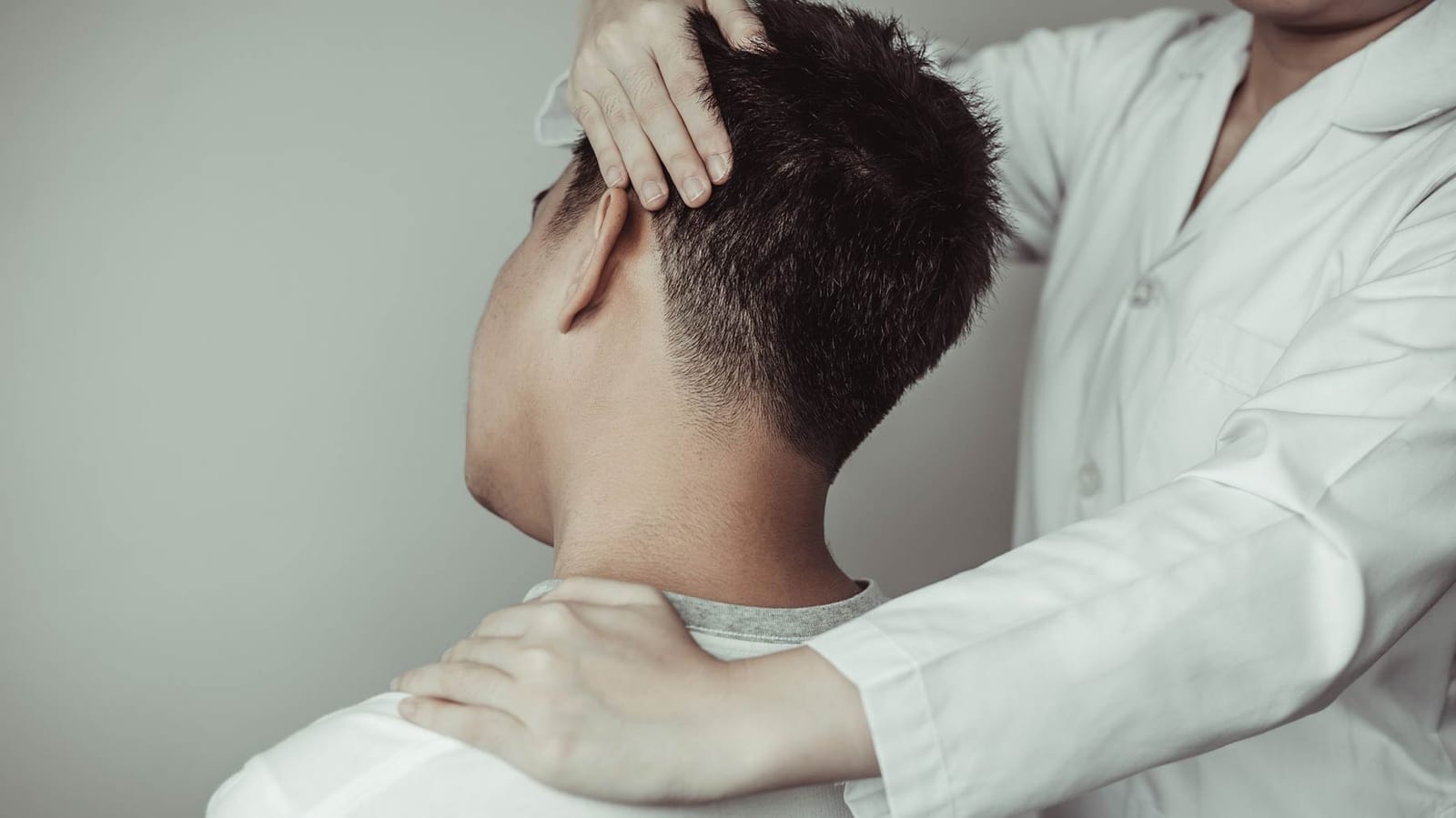 Physical therapy, Female physiotherapist examined the neck injuries of a male patient attending the clinic