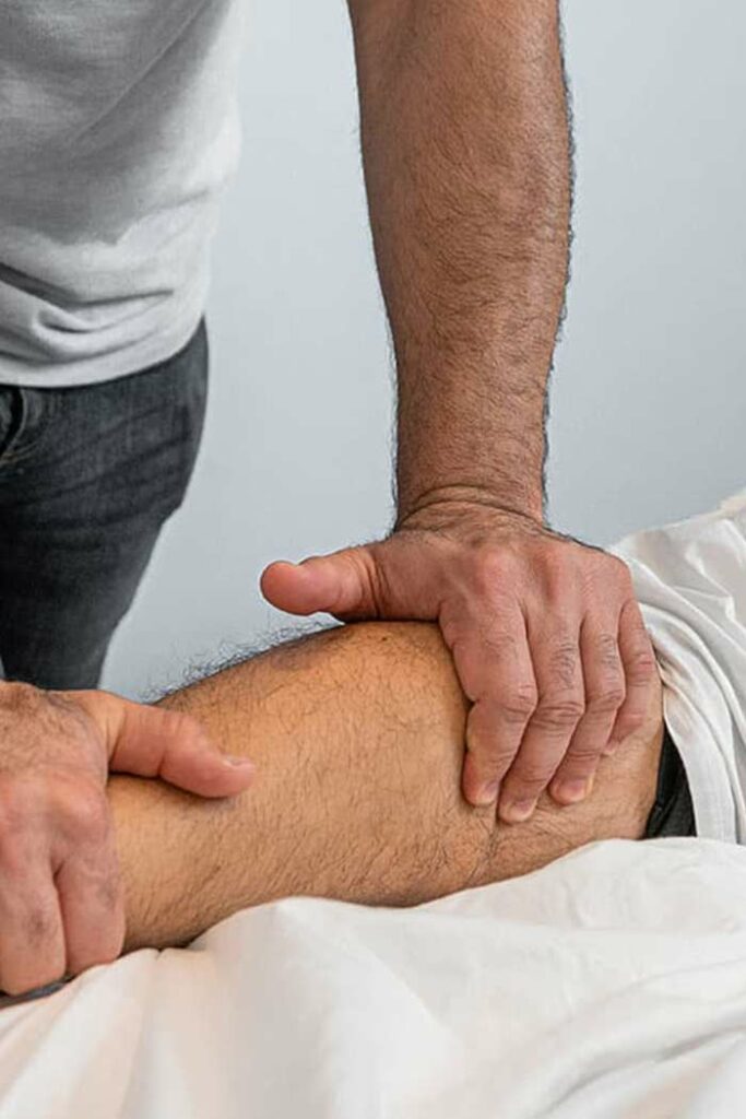 massage therapist working on patients leg