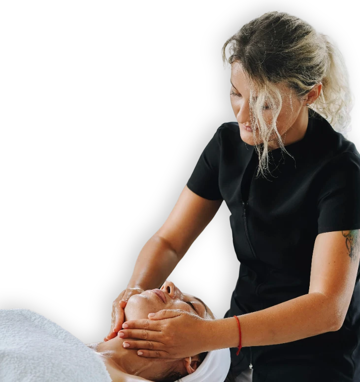 A Registered Massage Therapy professional giving a facial treatment to a relaxed client in North Vancouver.