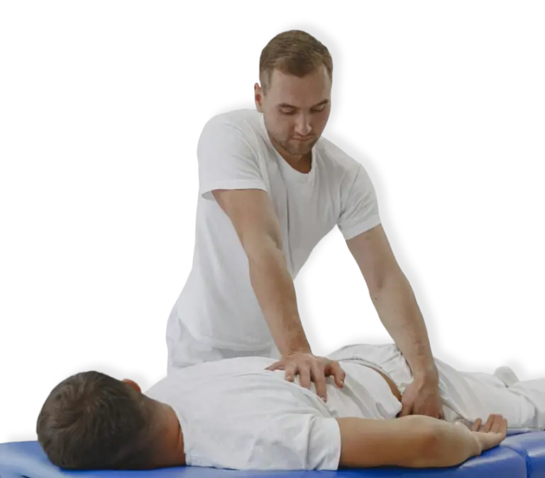 A chiropractor performing a back massage on a client lying face down on a massage table in North Vancouver.